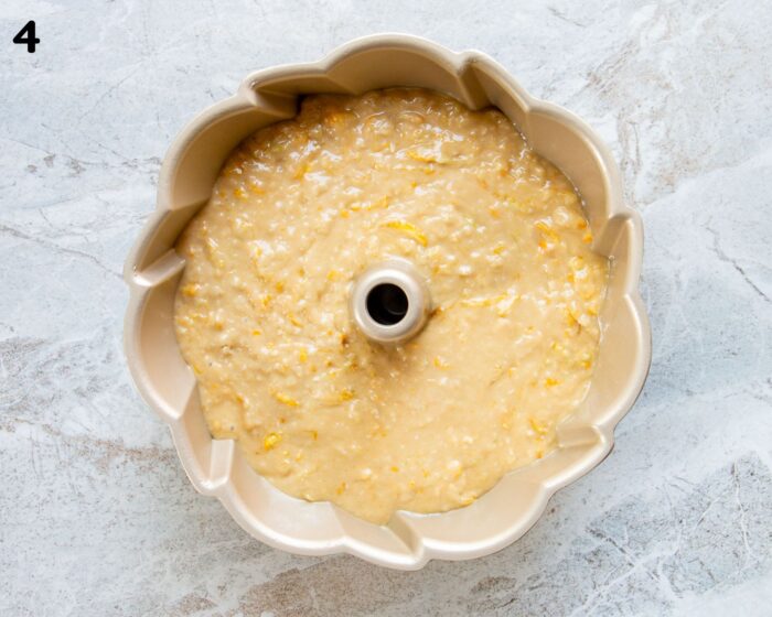 A bundt pan filled with lemon zucchini cake batter.