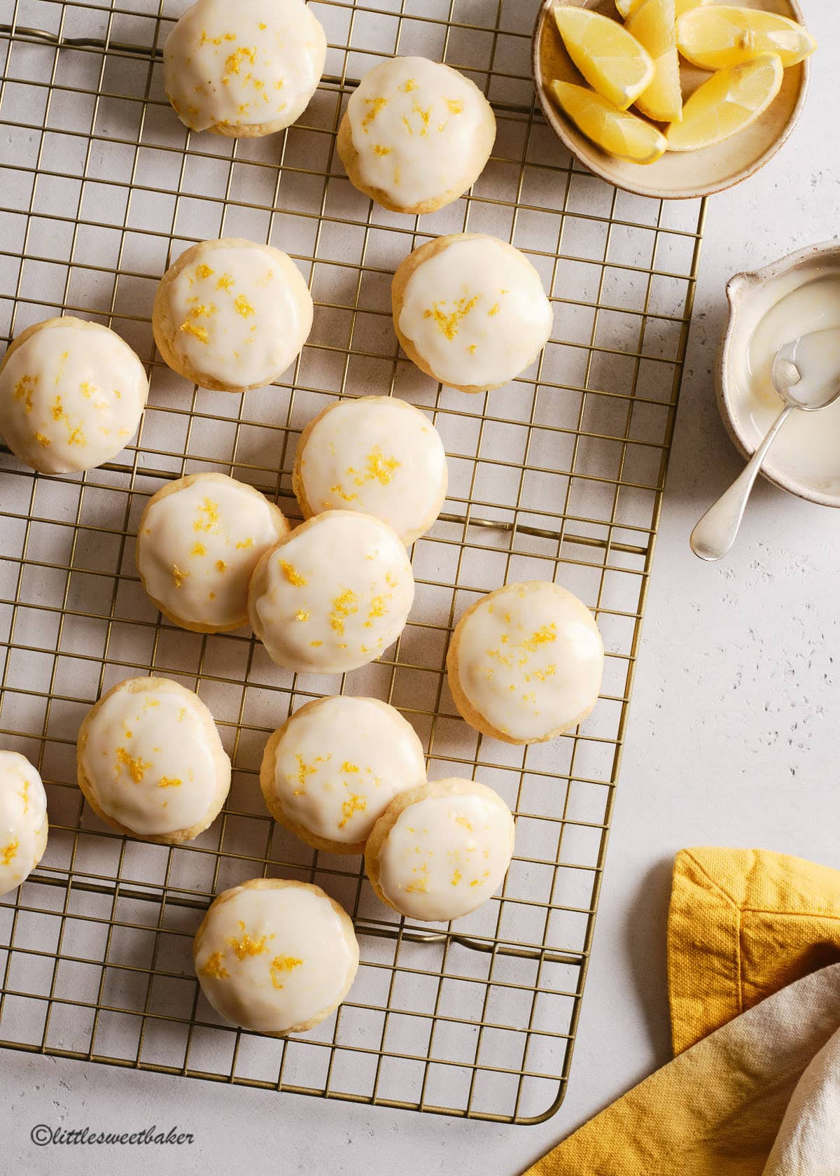 Overhead view of lemon ricotta cookies on a gold cooking rack.
