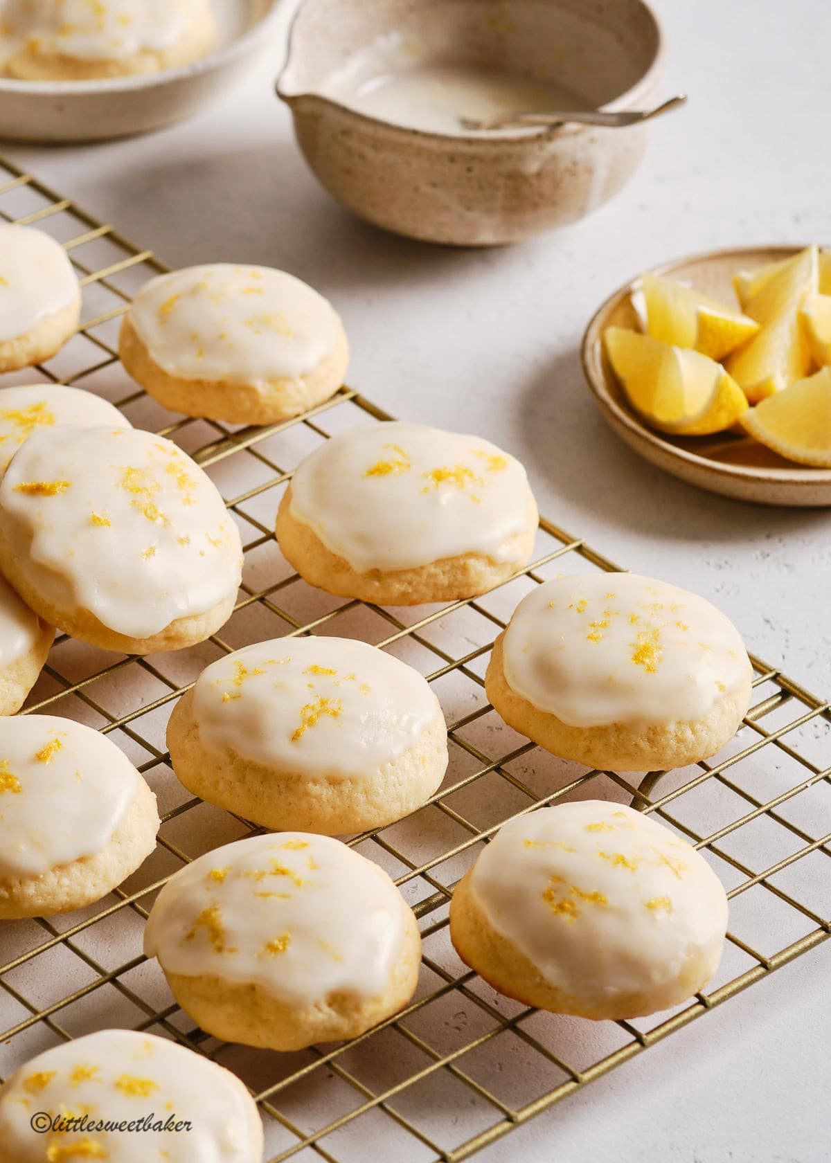 Lemon ricotta cookies on a gold cooling rack.