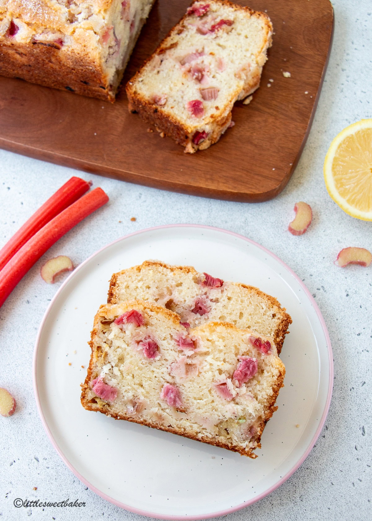 Two slices of lemon rhubarb bread on a pink and white plate.
