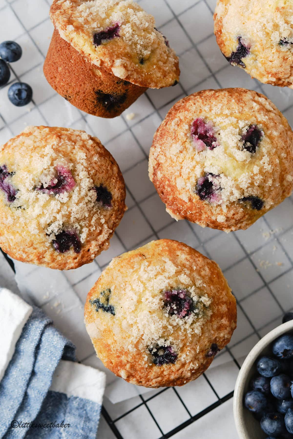 Overhead view of blueberry streusel muffins on a wire cooling rack.