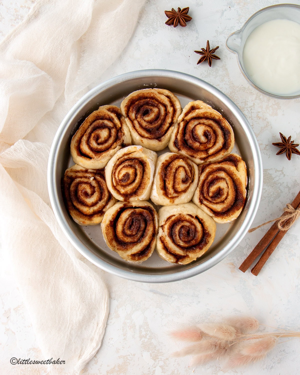 Healthy no-yeast cinnamon rolls in a silver metal cake pan without frosting.