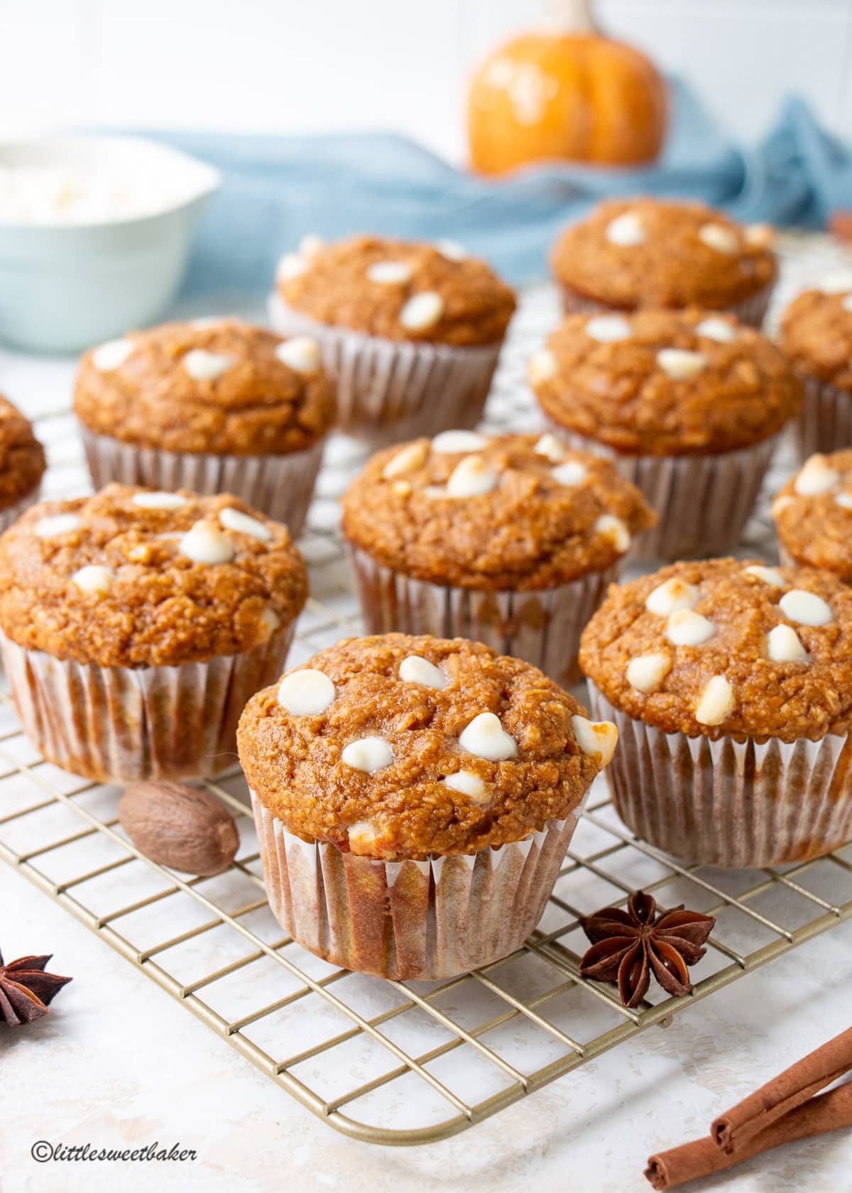 Protein pumpkin muffins on a gold cooling rack.