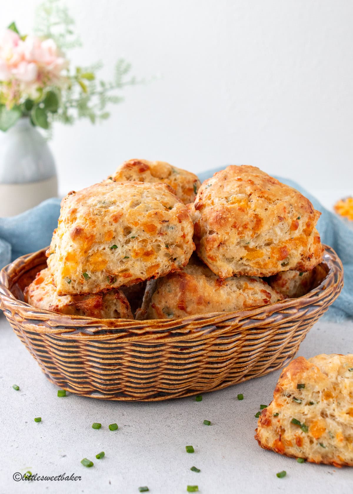 Cheesy lobster biscuits in a porcelain bread basket.