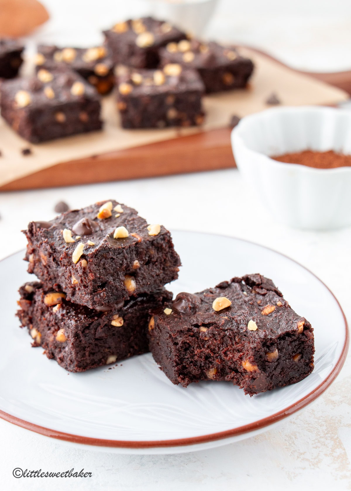 Three Sweet Potato Brownies on a small plate, with one missing a bite.