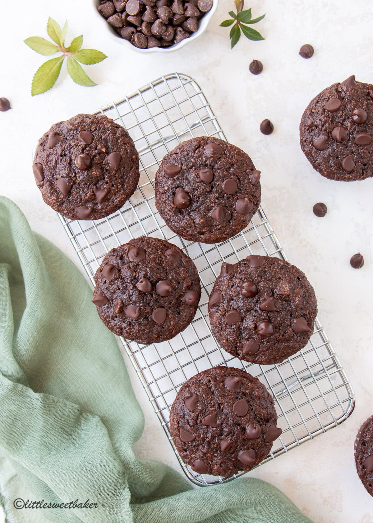 Overhead view of healthy chocolate zucchini muffins on a small cooling rack.