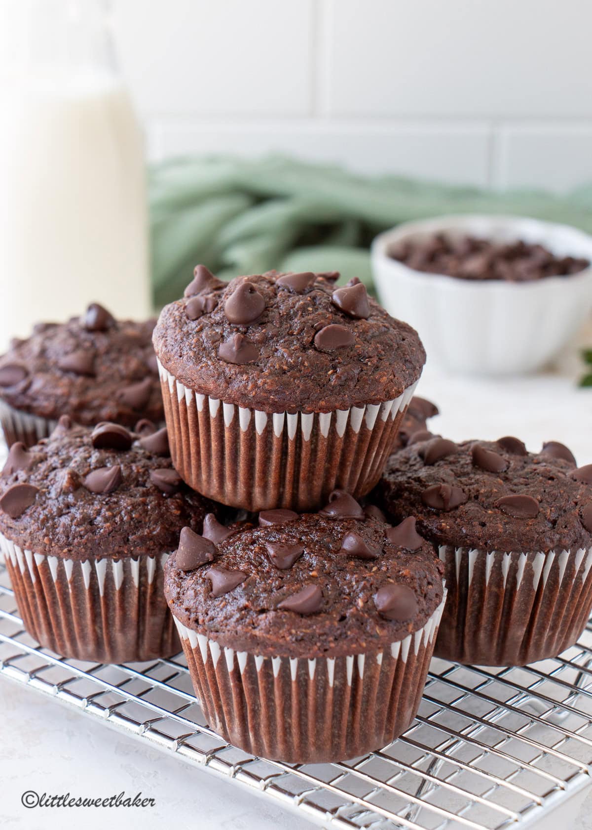 Healthy chocolate zucchini muffins on a small cooling rack.