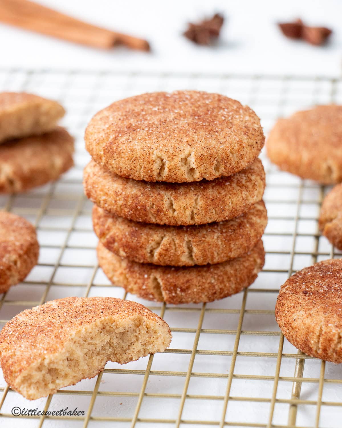 Healthy snickerdoodle cookies on a gold cooling rack.