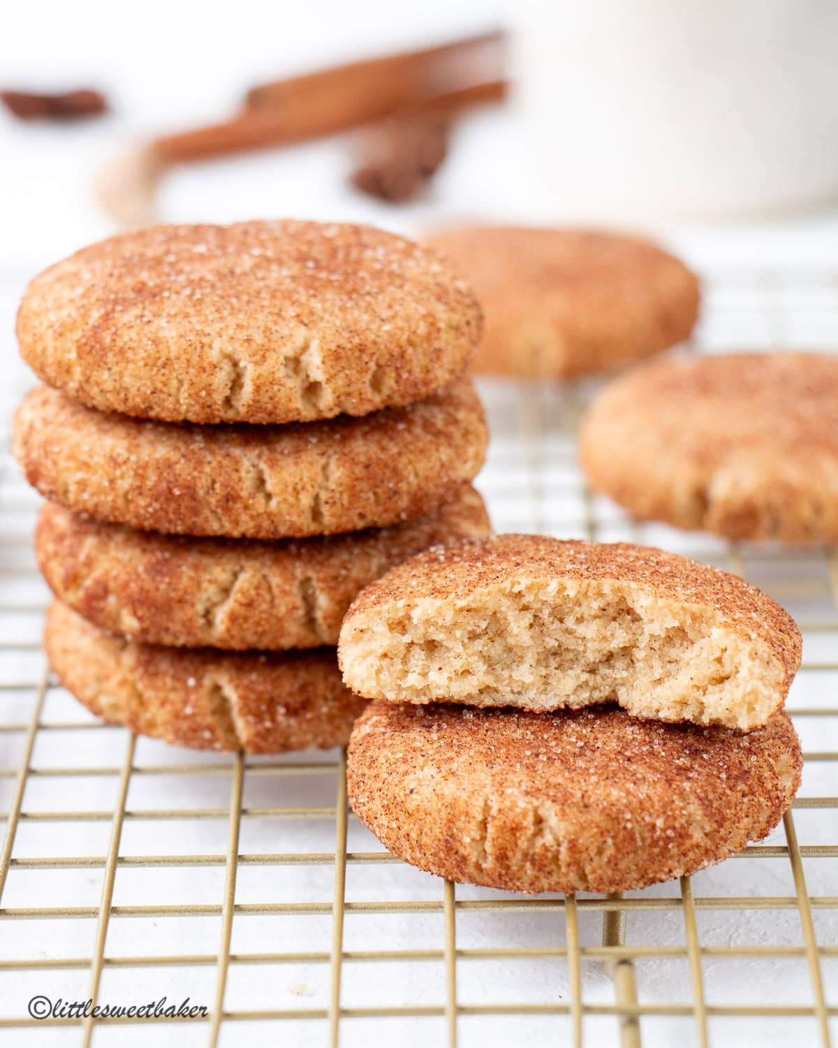Two stacks of healthy snickerdoodle cookies in a cooling rack.