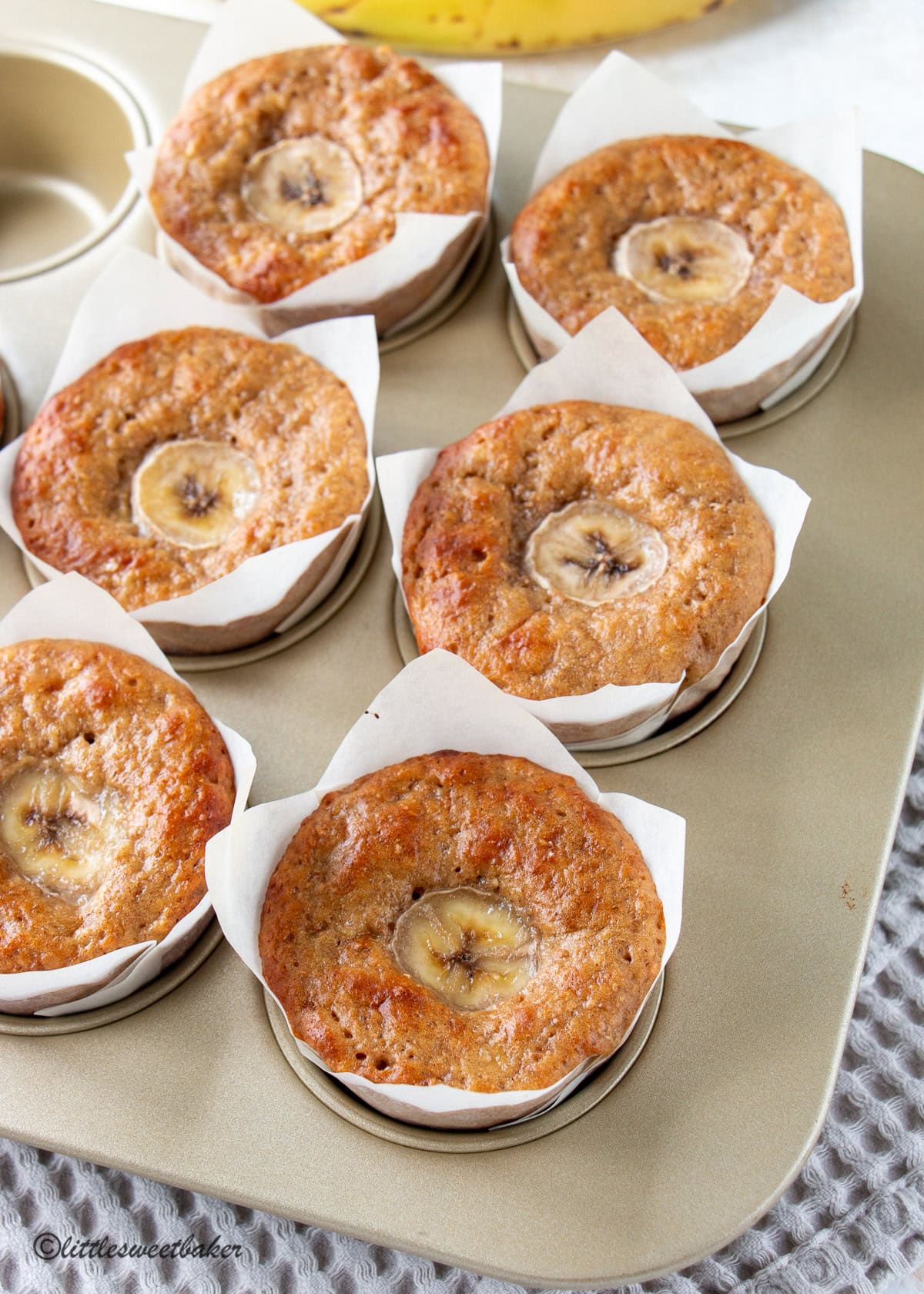 High-protein banana muffins in a gold baking pan.