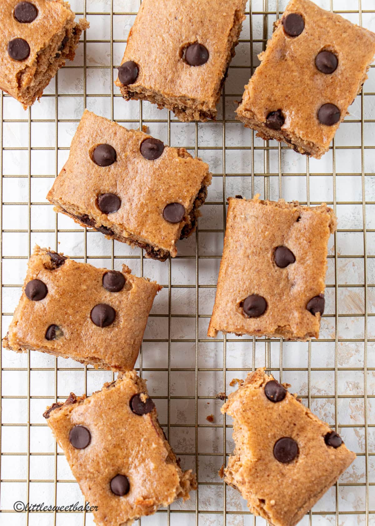 Overhead view of High-Protein Chocolate Chip Cake Bars on a cooling rack.