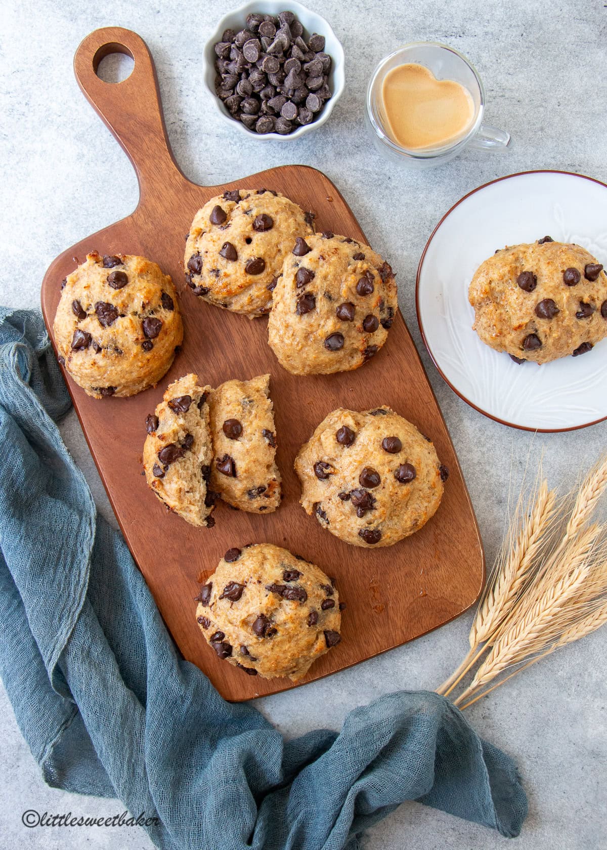 Healthy chocolate chip buns on a wooden serving board.