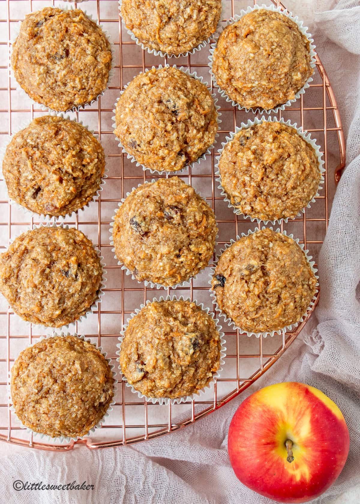 Healthy carrot cake muffin on a rose gold cooling rack.