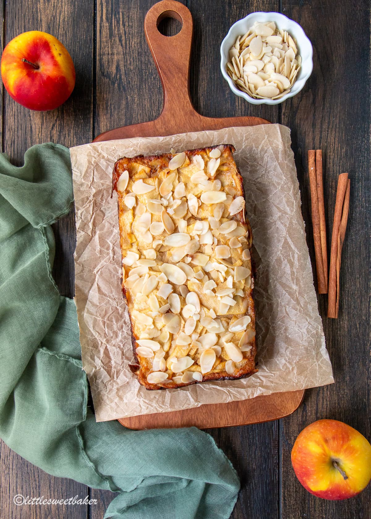 A healthy invisible apple cake on a wooden board lined with parchment paper.