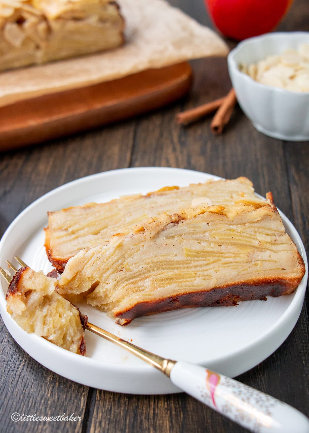 Two slices of healthy invisible apple cake on a white plate with a piece of cake on a fork.
