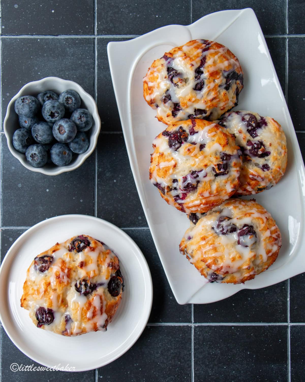 Healthy baked blueberry fritters on a white serving plate and small plate.