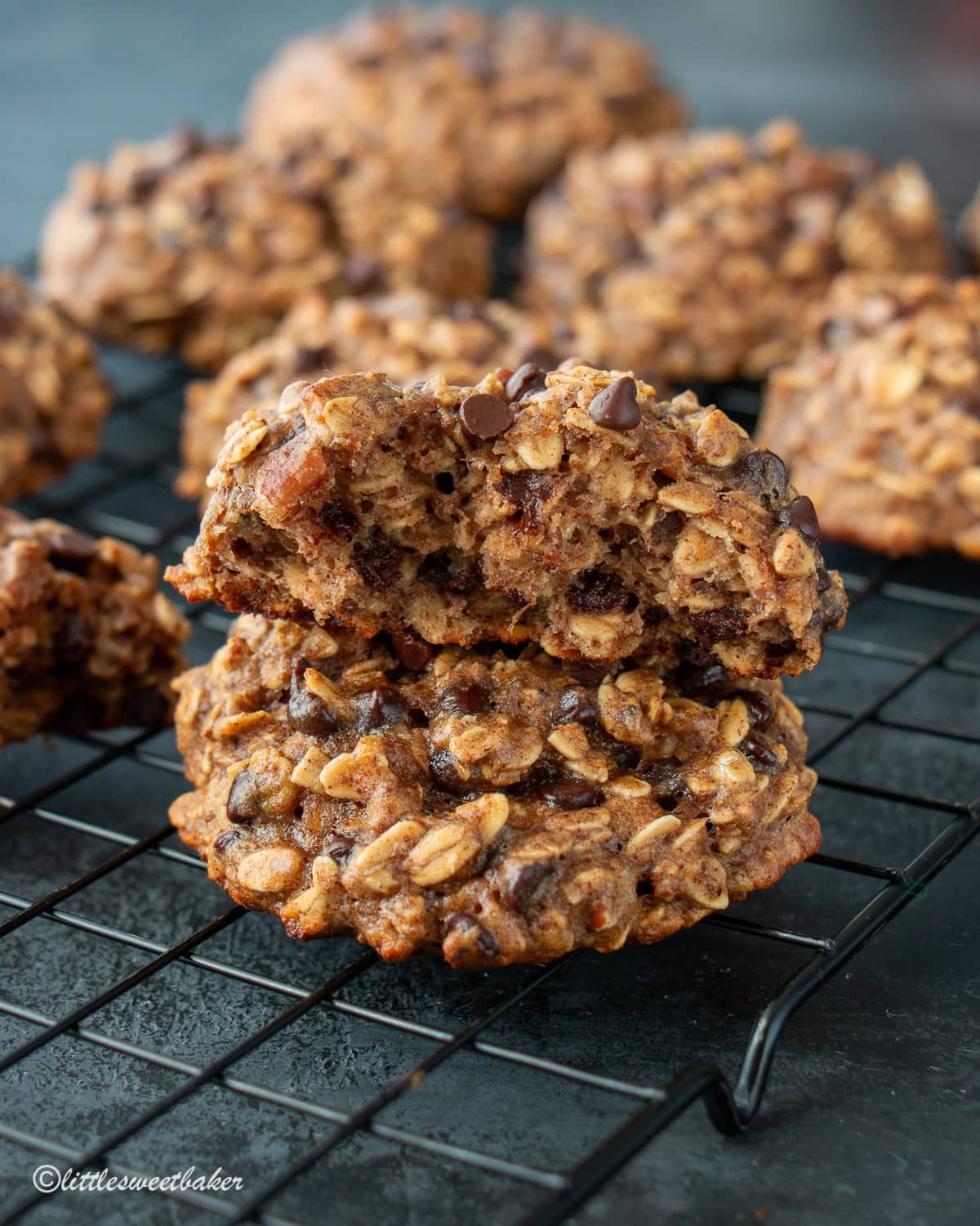 A close-up of two healthy banana oatmeal cookies stacked on top of one another.