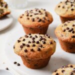 The BEST chocolate chip muffin recipe - soft, moist and fluffy, loaded with chocolate chips and a perfect crispy sky-high muffin top! Hundreds of rave review. #chocolatechipmuffins #easychocolatechipmuffins #bestchocolatechipmuffins #moistchocolatechipmuffins