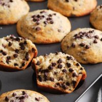 The BEST chocolate chip muffin recipe - soft, moist and fluffy, loaded with chocolate chips and a perfect crispy sky-high muffin top! Hundreds of rave review. #chocolatechipmuffins #easychocolatechipmuffins #bestchocolatechipmuffins #moistchocolatechipmuffins